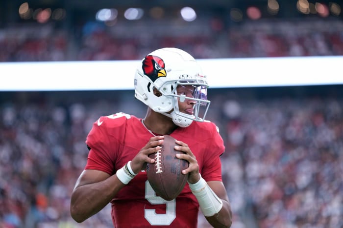 Josh Dobbs holds the football with both hands getting ready to throw